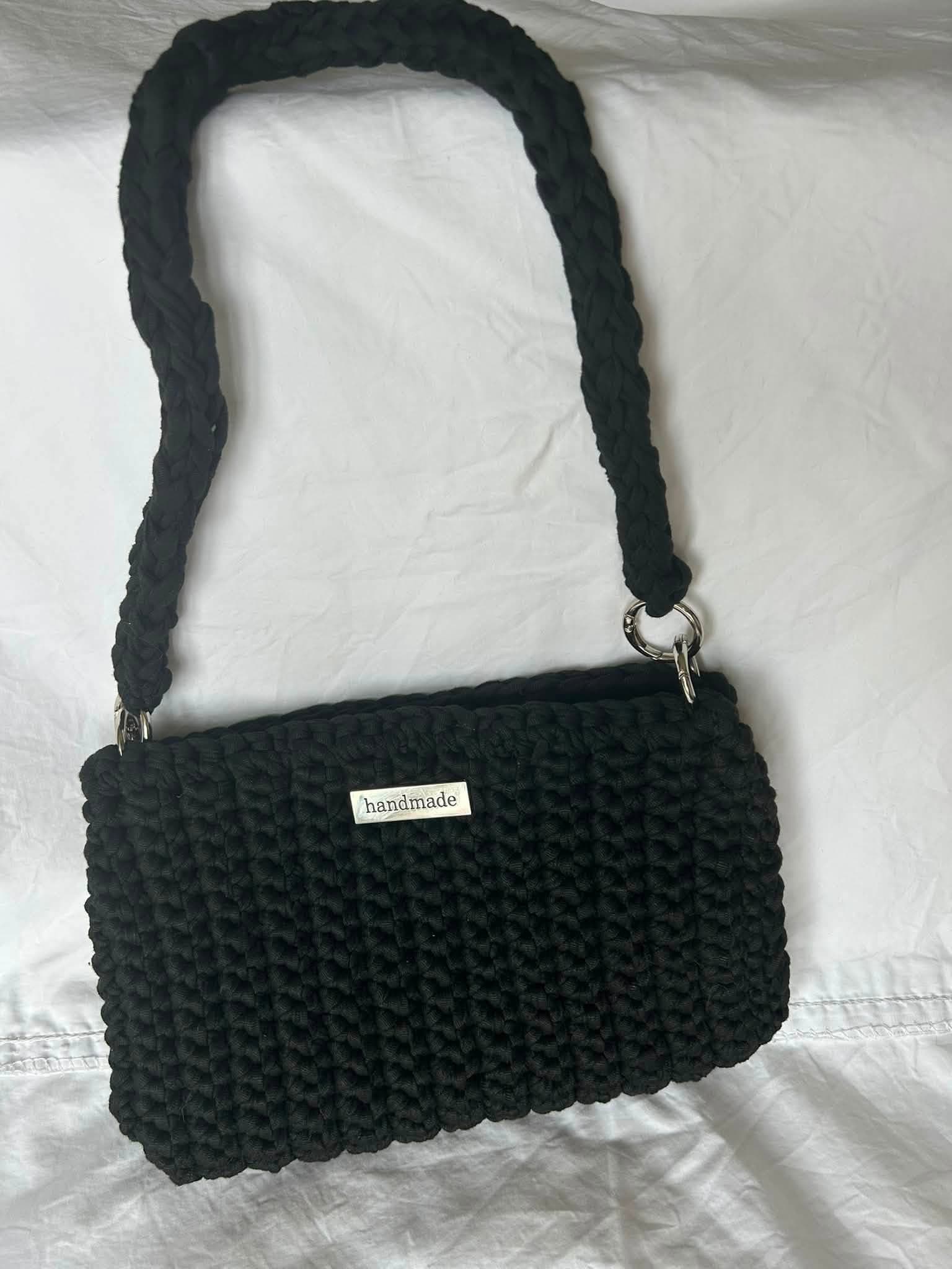Black small crochet bag with a long matching strap