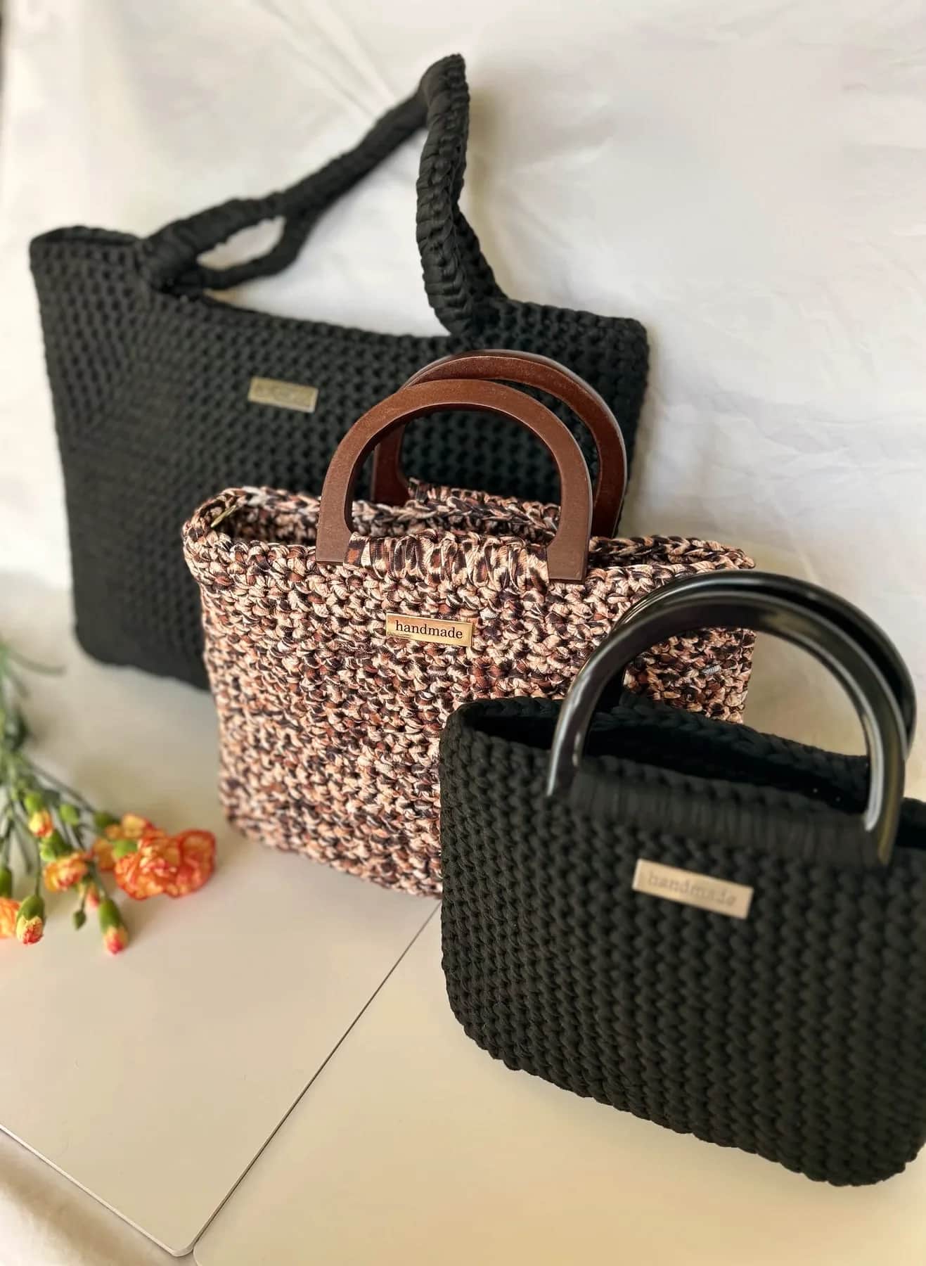Three crochet totes in black and marbled recycled yarn